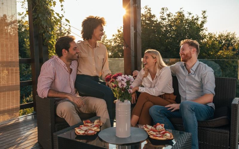 a group of people sitting on a couch outside