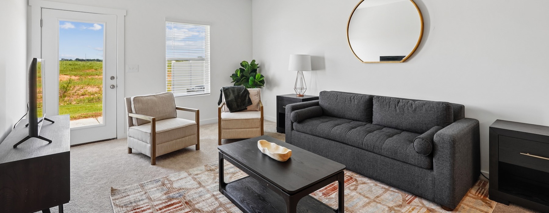 a living room with a couch, chairs and tables