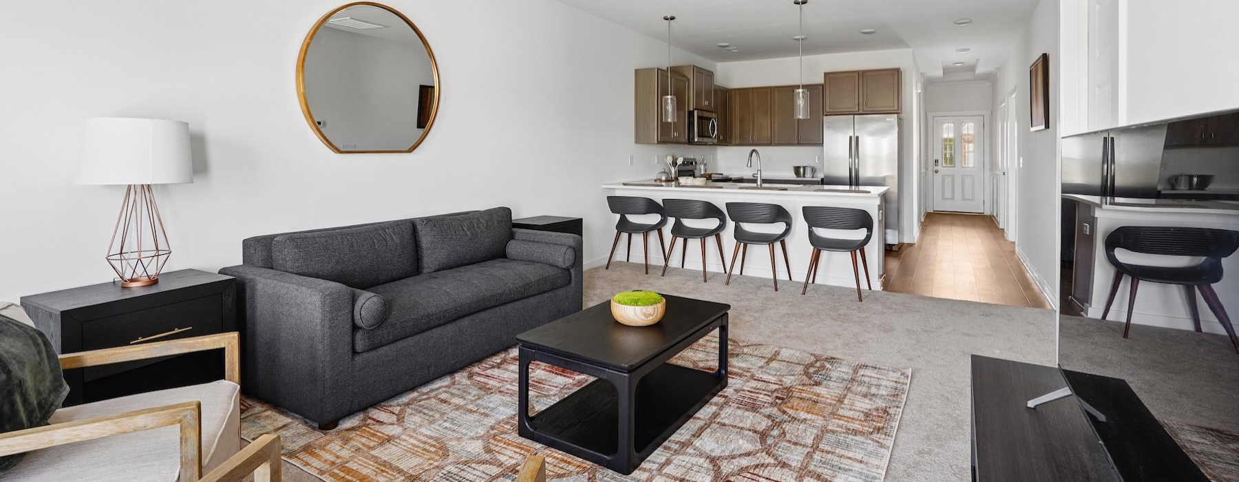 a living room with a couch, tables and chairs