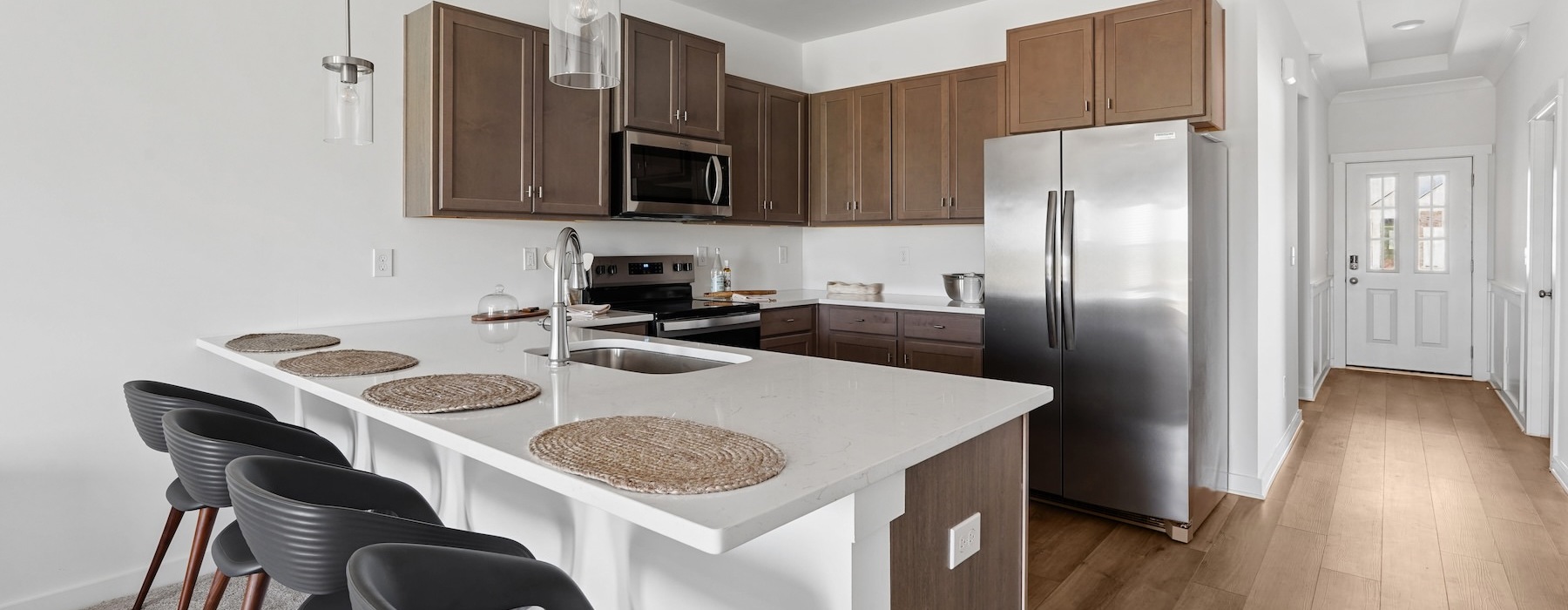 a kitchen with an island and chairs