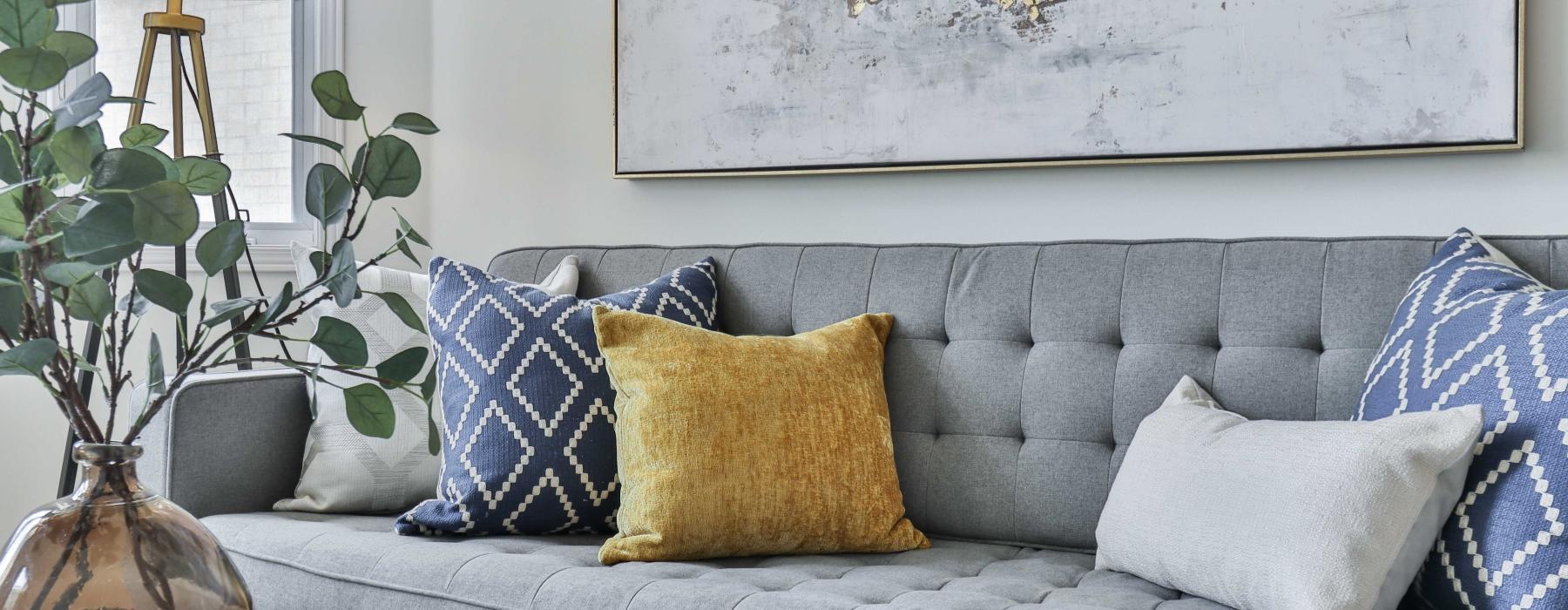 a couch with pillows and a table
